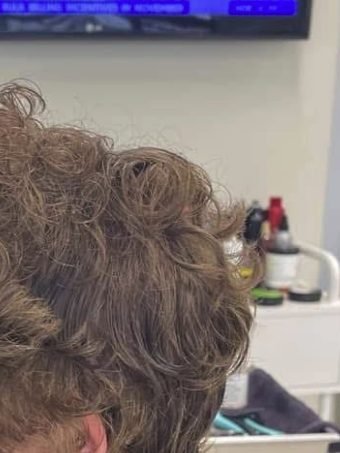 Before: a client’s grown-out curly hair